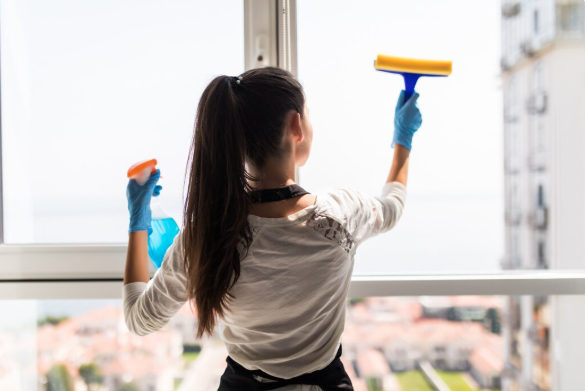 Female cleaner washing office windows in Melbourne